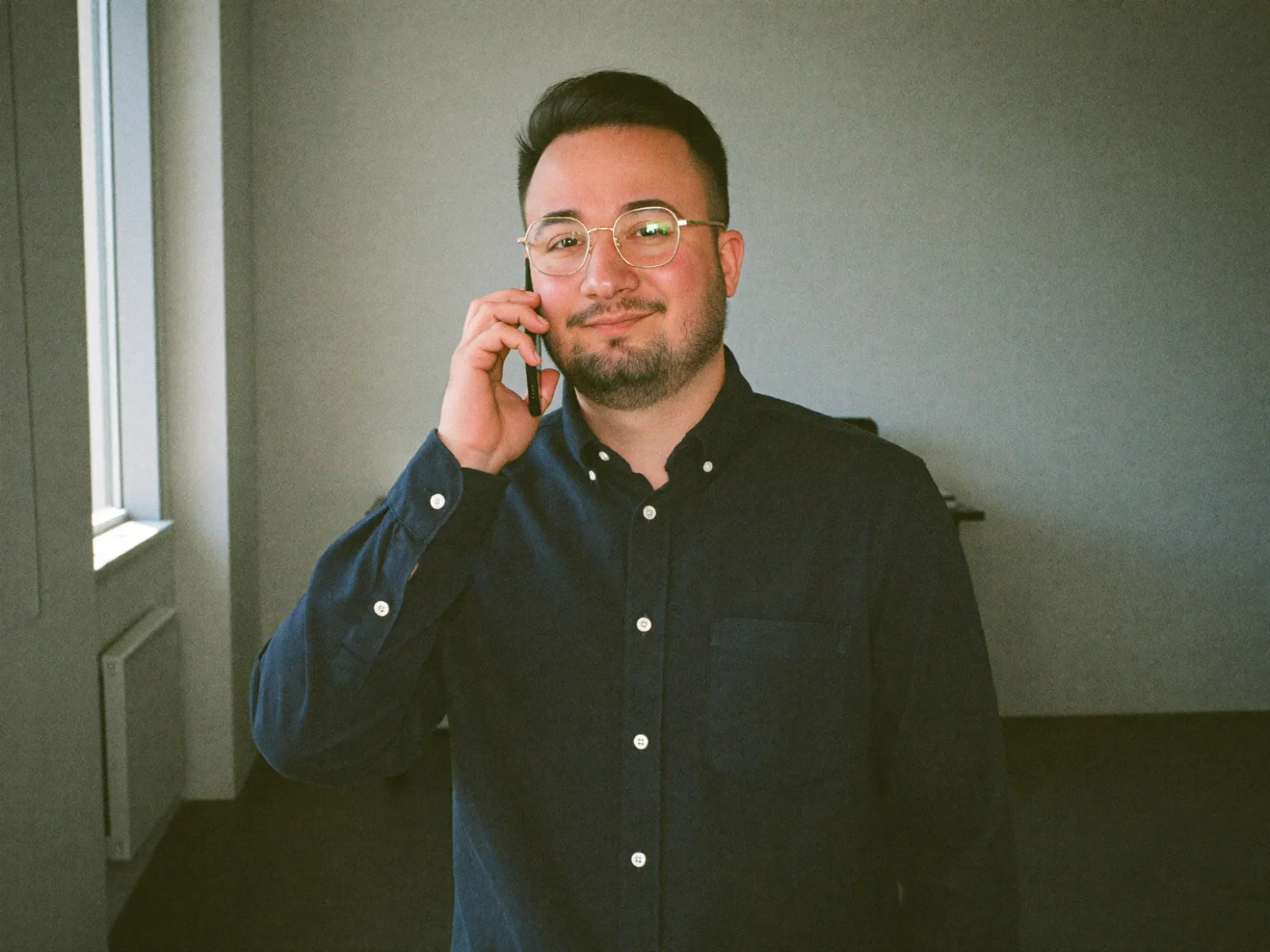 Dominik De Marco im Support-Telefonat am Bürofenster